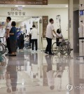 Medical staff members walk at a general hospital in Seoul on July 29, 2024. (Yonhap)