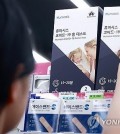 A person picks up COVID-19 self-test kits at a convenience store in Seoul on Aug. 7, 2024, amid signs of a resurgence in coronavirus cases. (Yonhap)