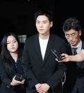 Suga of K-pop supergroup BTS (2nd from L), whose legal name is Min Yoon-ki, appears before Yongsan Police Station in Seoul on Aug. 23, 2024, to face questioning over his alleged drunk driving on an electric scooter earlier this month. (Yonhap)