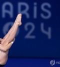 In this Reuters photo, Woo Haram of South Korea competes in the semifinal of the men's 3-meter springboard diving event at the Paris Olympics at the Aquatics Centre in Saint-Denis, France, on Aug. 7, 2024. (Yonhap)