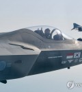 A KF-21 fighter jet prototype (front) flies alongside an F-4E jet in this file photo provided by the Air Force on May 12, 2024. (PHOTO NOT FOR SALE) (Yonhap)