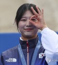 In this file photo, Lim Si-hyeon of South Korea celebrates on the podium after winning the gold medal in the women's archery individual event at the Paris Olympics at Invalides in Paris on Aug. 3, 2024. (Yonhap)