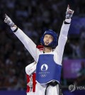 Kim Yu-jin of South Korea celebrates after winning the gold medal in the women's -57-kilogram taekwondo event at the Paris Olympics at Grand Palais in Paris on Aug. 8, 2024. (Yonhap)