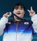 Park Hye-jeong of South Korea celebrates on the podium after winning silver in the women's +81-kilogram weightlifting event at the Paris Olympics at South Paris Arena 6 in Paris on Aug. 11, 2024. (Yonhap)