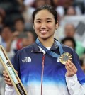 An Se-young of South Korea poses with her gold medal won in the women's singles badminton event at the Paris Olympics at Porte de La Chapelle Arena in Paris on Aug. 5, 2024. (Yonhap)