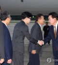 President Yoon Suk Yeol (R) shakes hands with ruling People Power Party chief Han Dong-hoon (3rd from L) at Seoul Air Base in Seongnam, just south of Seoul, on Sept. 22, 2024, as Yoon arrives in South Korea after a trip to the Czech Republic. (Yonhap)