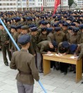 Young people, including students and youth league officials, sign petitions to join or return to the army this week, according to North Korean state media, at an undisclosed location in North Korea, in this undated photo released by North Korea's official Korean Central News Agency October 16, 2024. KCNA via REUTERS ATTENTION EDITORS - THIS IMAGE WAS PROVIDED BY A THIRD PARTY. REUTERS IS UNABLE TO INDEPENDENTLY VERIFY THIS IMAGE. NO THIRD PARTY SALES. SOUTH KOREA OUT. NO COMMERCIAL OR EDITORIAL SALES IN SOUTH KOREA.