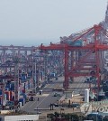 Shipping containers are stacked at a port in the southeastern city of Busan, in this file photo taken April 1, 2024. (Yonhap)