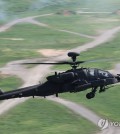 In this file photo, a U.S. Apache helicopter maneuvers over the Rodriguez Live Fire Complex in Pocheon, 52 kilometers northeast of Seoul, on Aug. 14, 2024, as part of a rapid deployment drill. (Yonhap)