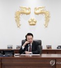 President Yoon Suk Yeol talks over the phone with Japan's new Prime Minister Shigeru Ishiba at his office in Seoul on Oct. 2, 2024, in this photo provided by the presidential office. (PHOTO NOT FOR SALE) (Yonhap)