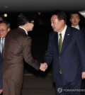 President Yoon Suk Yeol (R) shakes hands with Han Dong-hoon, leader of the ruling People Power Party, at Seoul Air Base in Seongnam, south of Seoul, on Oct. 11, 2024, upon Yoon's return from his three-nation Southeast Asia trip. (Yonhap)