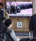 People watch news coverage of North Korea's alleged troop dispatch to Russia, at Seoul Station in the capital on Oct. 20, 2024. (Yonhap)