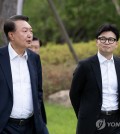 President Yoon Suk Yeol (L) and Han Dong-hoon, leader of the ruling People Power Party, meet at the presidential office in Seoul on Oct. 21, 2024, in this photo provided by Yoon's office. (PHOTO NOT FOR SALE) (Yonhap)