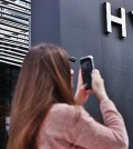 A fan takes a photo outside the headquarters of Hybe in Seoul in this Sept. 25, 2024, file photo. (Yonhap)