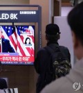 People watch a live broadcast of the U.S. presidential election at Seoul Station in central Seoul on Nov. 6, 2024. (Yonhap)