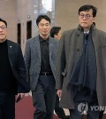 Bank of Korea Gov. Rhee Chang-yong (R) moves after an emergency meeting on economic affairs in Seoul, along with Financial Supervisory Service chief Lee Bok-hyun (C) and Financial Services Commission head Kim Byoung-hwan (L), on Dec. 6, 2024.(Yonhap)