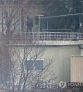 A person believed to be a security guard patrols at impeached President Yoon Suk Yeol's official residence in Seoul on Jan. 13, 2025, one week after a court issued a second warrant to detain Yoon in connection to his short-lived imposition of martial law. (Yonhap)