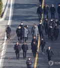 Investigators from the state anti-corruption agency and police officers leave the premises of impeached President Yoon Suk Yeol's official residence in Seoul on Jan. 3, 2025, after failing to execute a warrant to detain Yoon over his failed bid to impose martial law in December. (Yonhap)