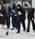 In this file photo, members of K-pop girl group NJZ, formerly NewJeans, walk out after attending a hearing on their agency's request for an injunction banning their independent activities at the Seoul Central District Court in the capital on March 7, 2025. (Yonhap)